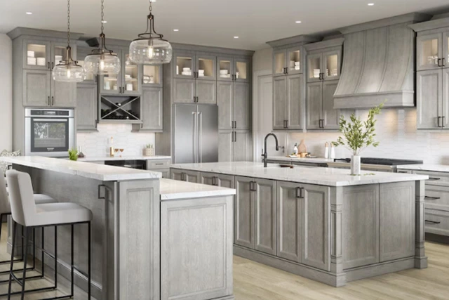 Modern gray kitchen with island, stainless steel appliances, and pendant lighting.