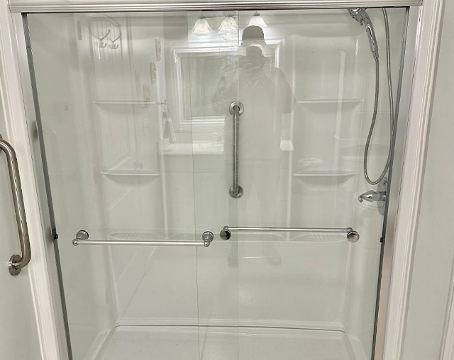 Accessible shower with grab bars, installed by remodeling experts.