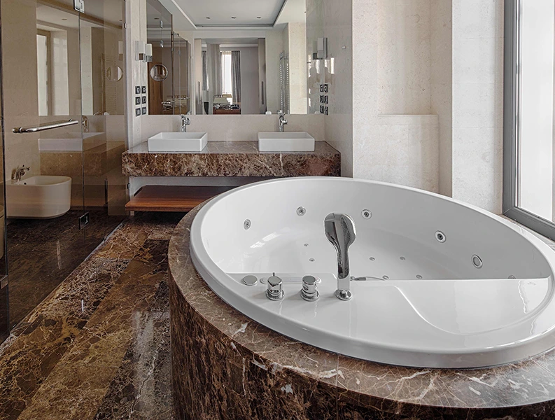 Luxurious bathroom featuring a white jacuzzi tub and marble flooring, ideal for Jacuzzi Bathroom Remodel.
