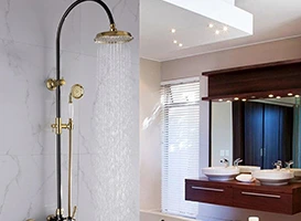 Modern bathroom with rainfall shower, hand shower, and floating vanity with vessel sink.