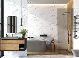 Modern bathroom with marble wall, gray tub, and wood accents.