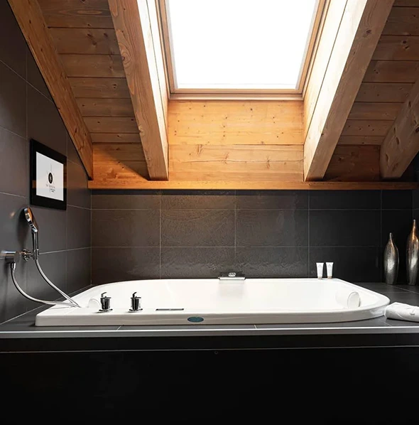 Modern jacuzzi bathroom with skylight; remodel services available.