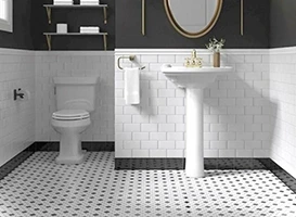 Bathroom with white subway tile walls, pedestal sink, toilet, and durable bathroom floor tiles.