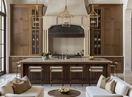 Elegant kitchen with wood cabinets, island with seating, and decorative range hood.