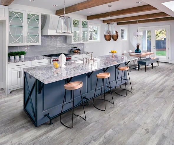 Open concept kitchen remodel in Bar Harbor featuring a large island with seating and white cabinets.